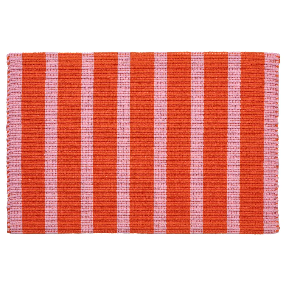 This is a rectangular VÄGSKYLT door mat with orange and pink stripes, made of cotton.