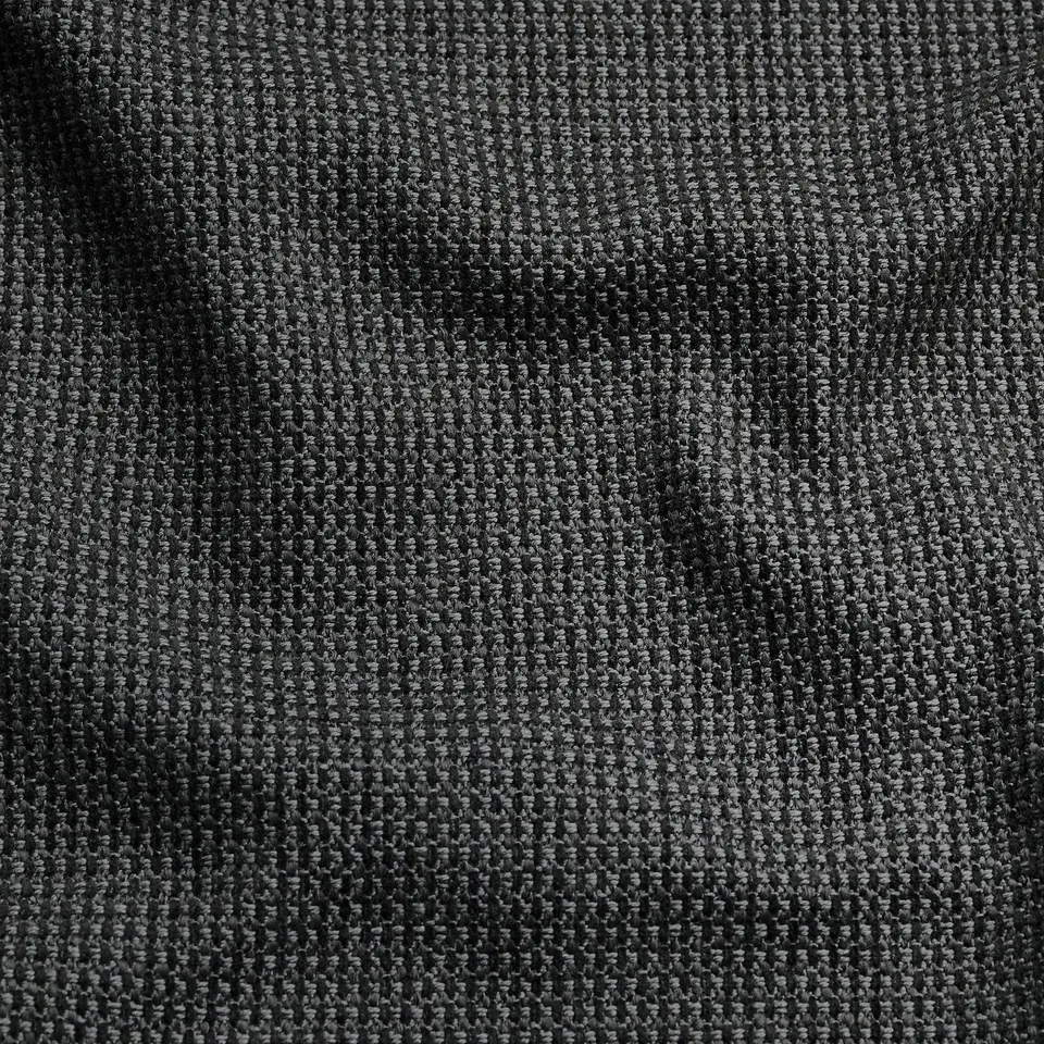 Soft, textured fabric in shades of grey, likely from KIVIK footstool, feels durable and comfortable.