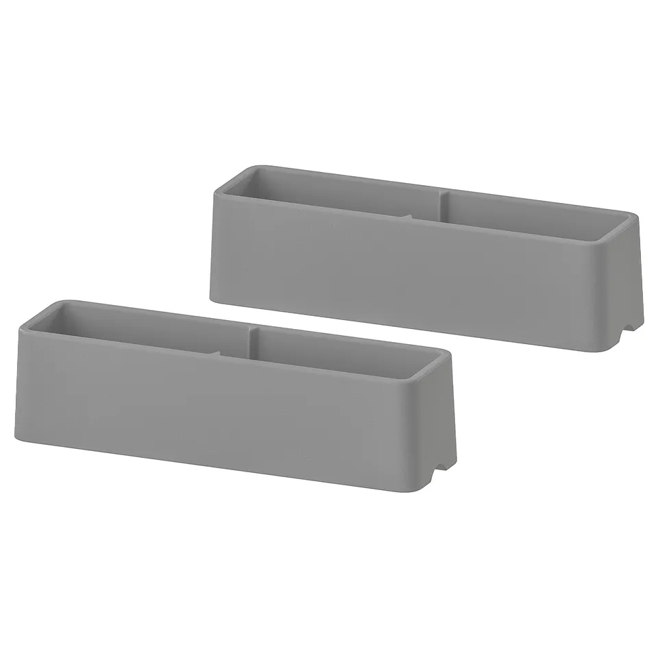Two grey rectangular plastic furniture guards.