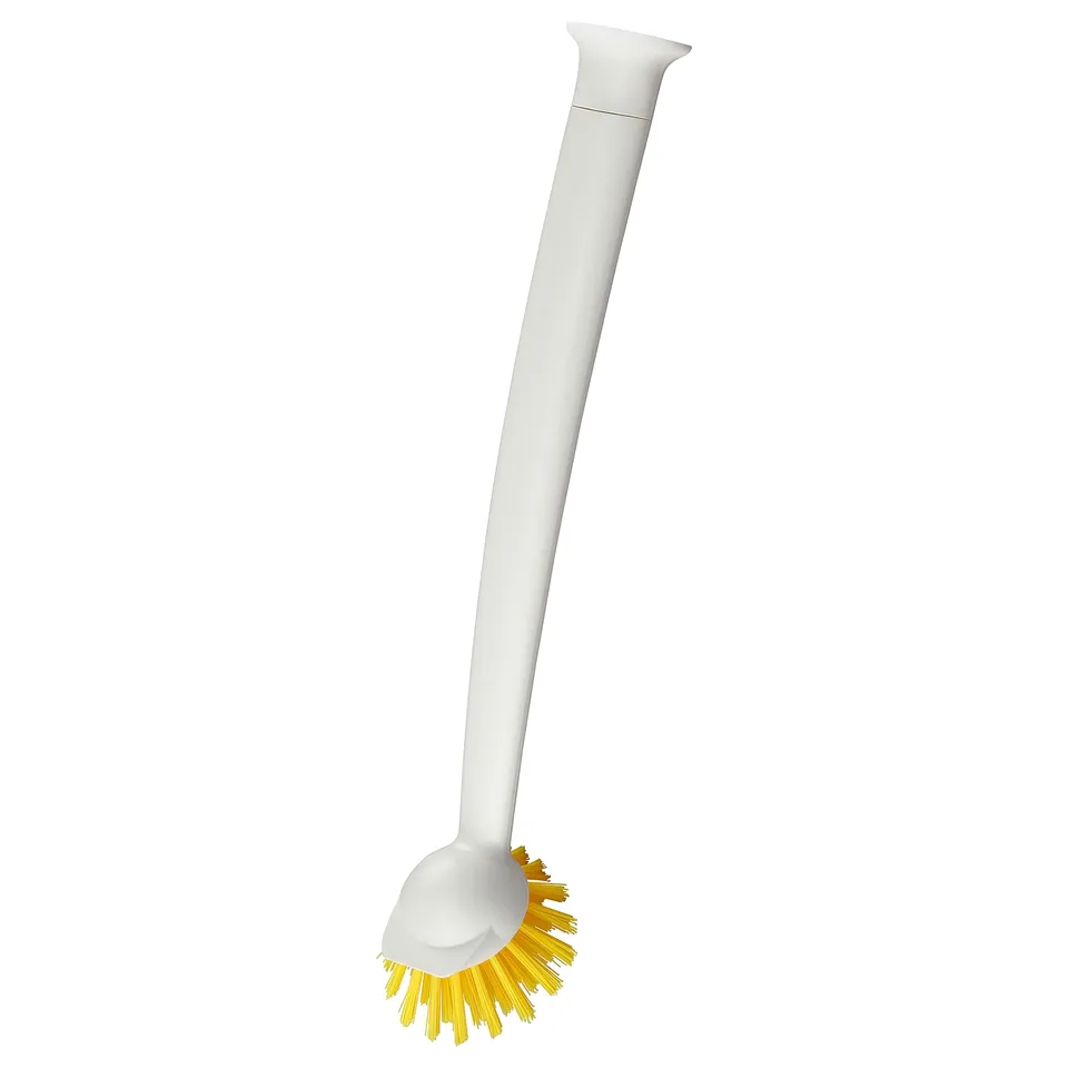 A white RINNIG kitchen brush with a yellow bristle and a suction cup at the bottom for sticking to surfaces.
