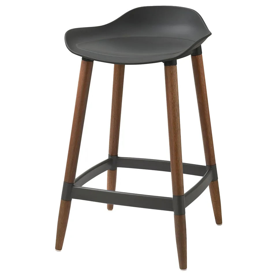 A black GRÖNSTA counter-height bar stool with a moulded seat and wooden legs. Its a stylish, sturdy option for kitchen counters.
