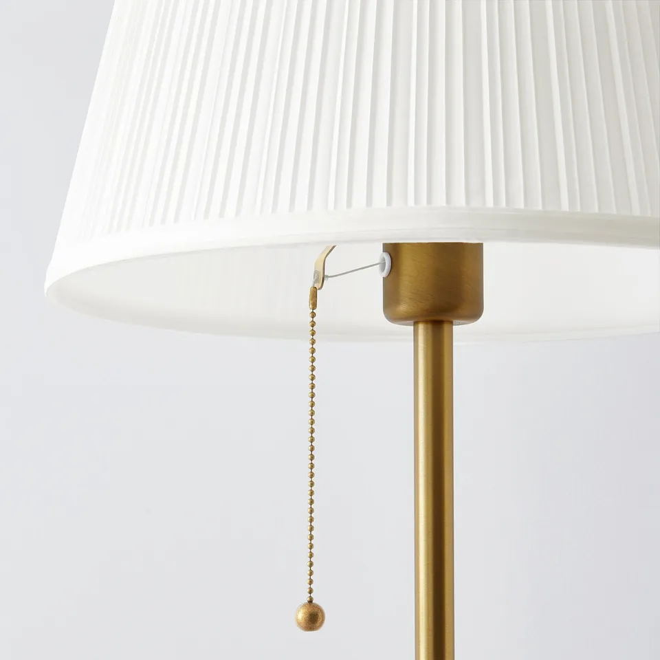 Gold lamp with textured white shade & pull chain. Elegant & stylish design.