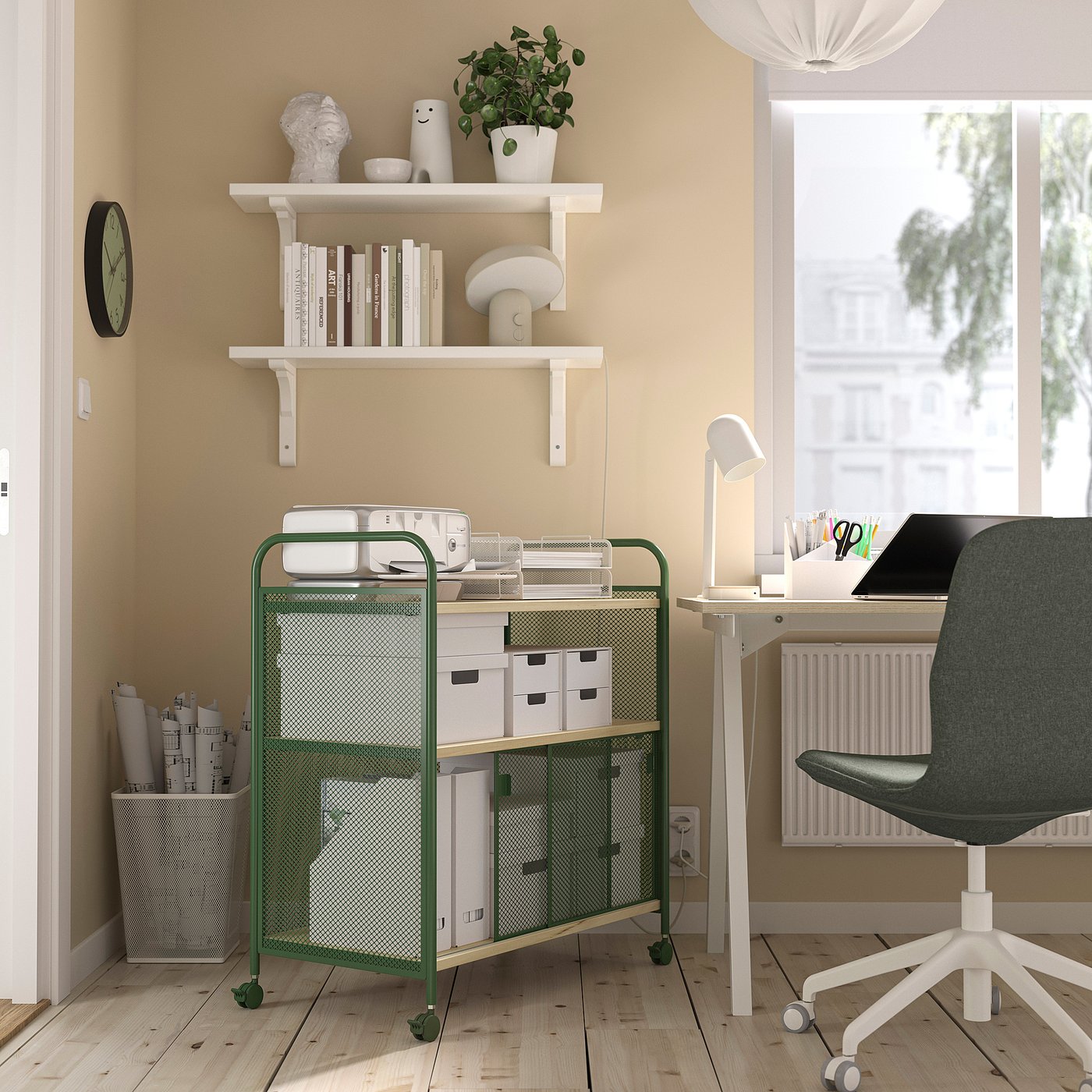 Home office with NÅLMAKARE cart, laptop, lamp, and chair.