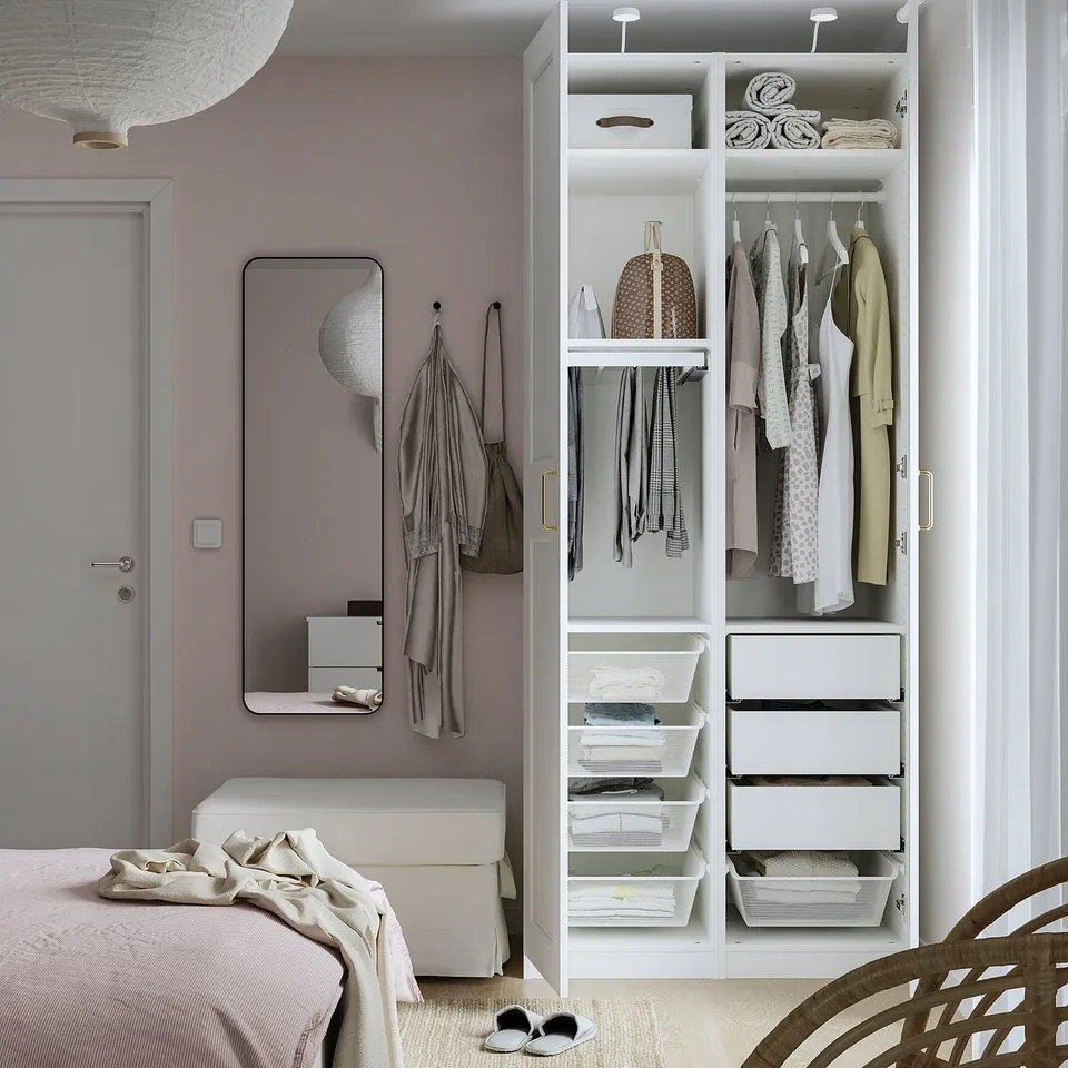 Well-organized bedroom with a PAX wardrobe offering airy and drawer storage, hanging space, and a bench.