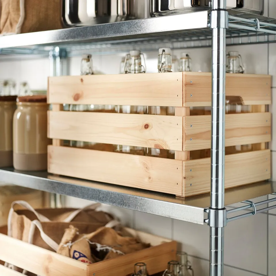 Metal shelf with wooden storage boxes, glass jars, and cloth bags, for organising kitchen items.