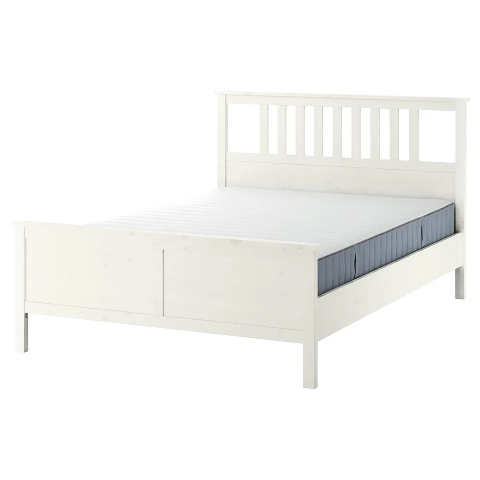 White wooden HEMNES bed with wooden slats and padded headboard.