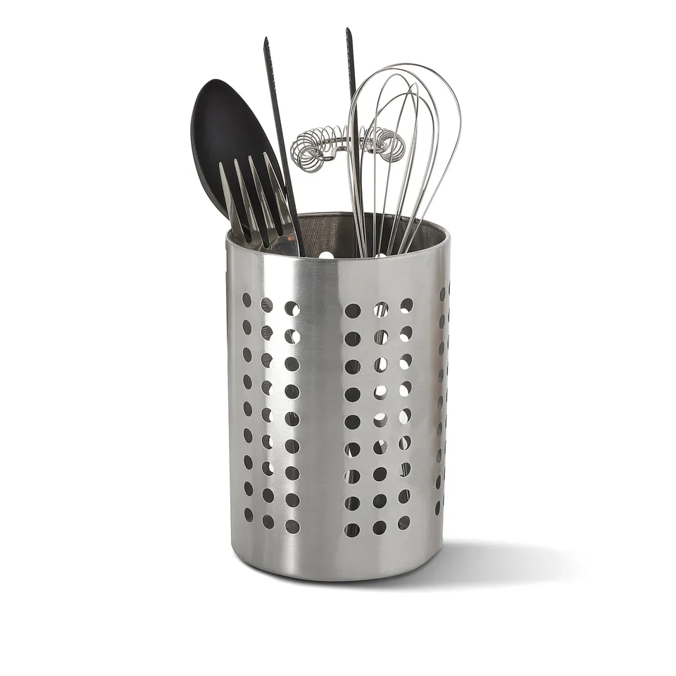 Circular silver utensil holder with ventilation, holding spatula, tongs, and whisks near sink/stove.