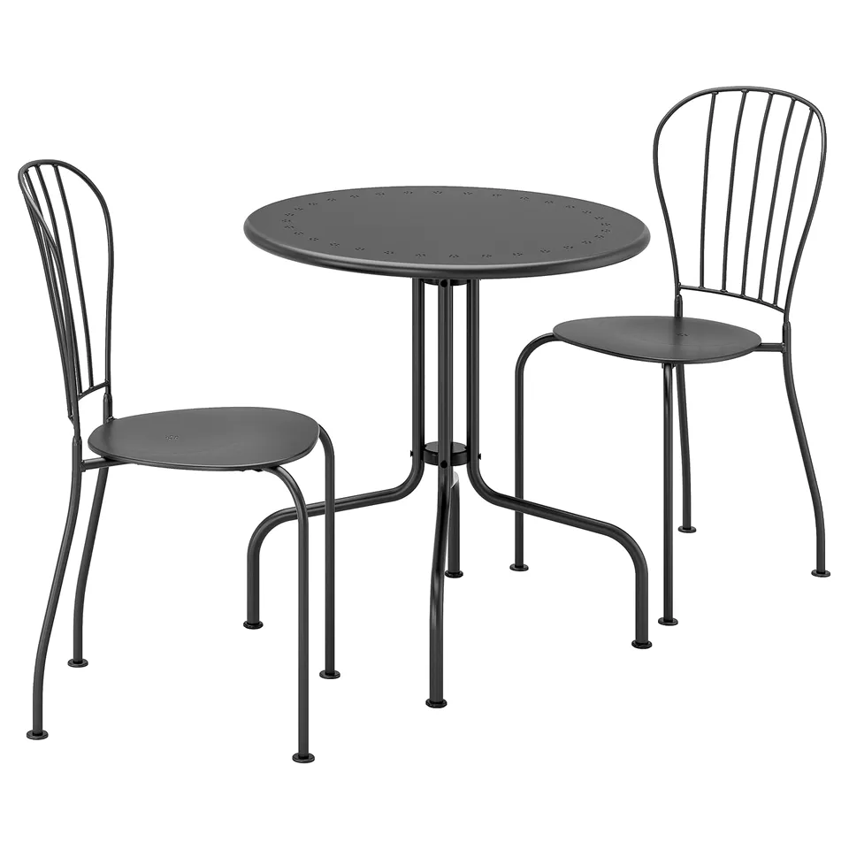 Black LÄCKÖ outdoor table and chairs, steel & plastic, modern wrought-iron design, drainage holes in seats.