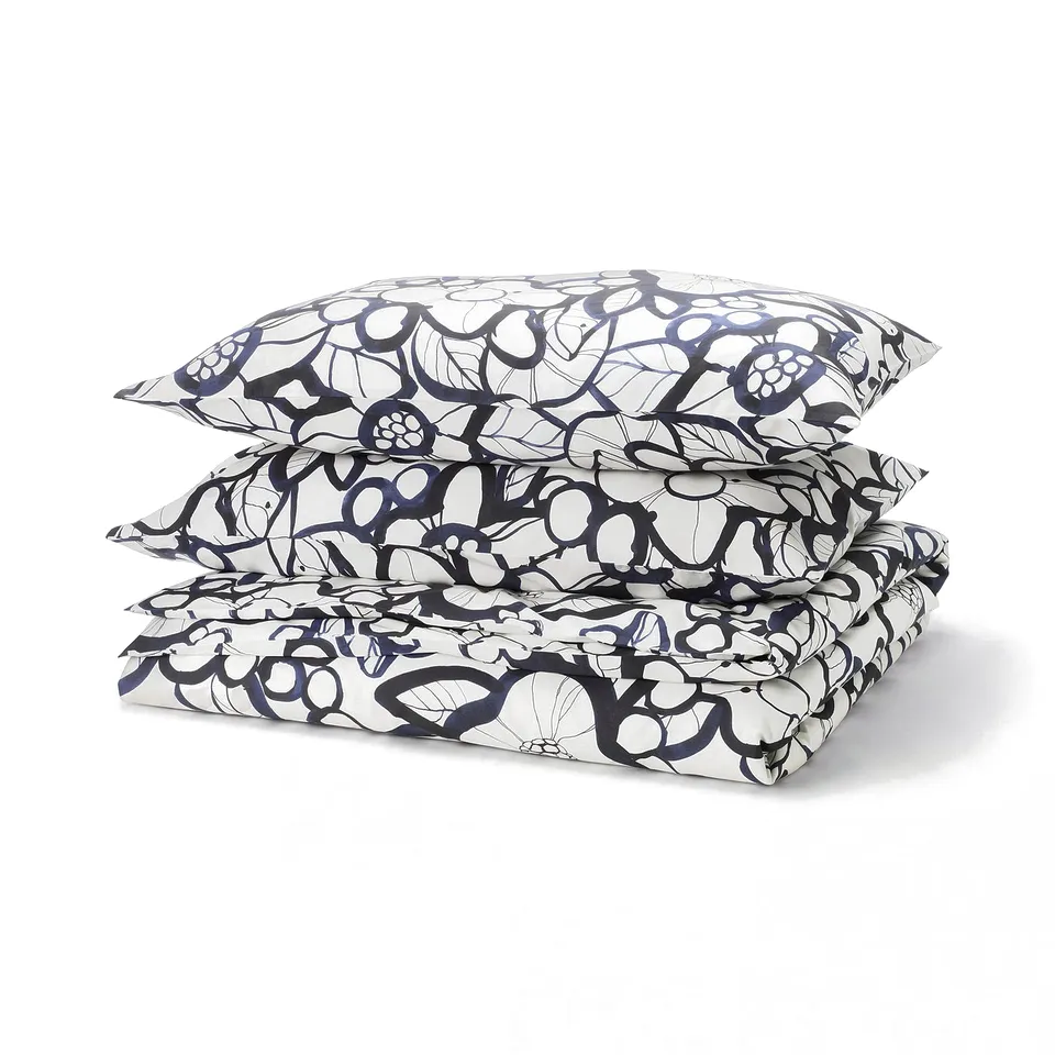 Folded black/blue floral bedding set, rectangular shape with natural motifs, smooth fabric.