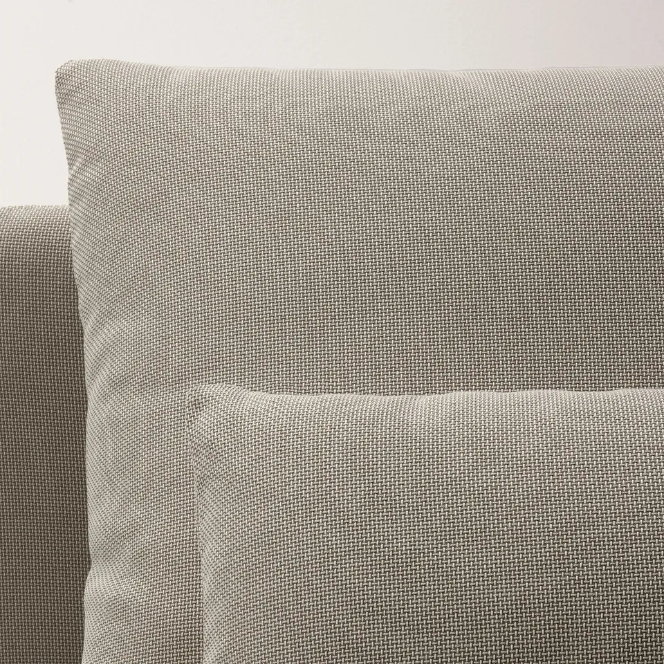 Close-up of a plush, textured grey sofa, showcasing high-quality fabric and deep cushions.