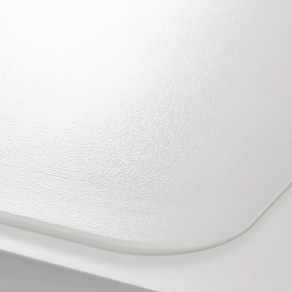 Close-up of a white desk pads smooth, protective surface.