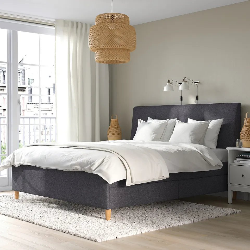 Modern bedroom with IDANÄS dark grey bed, four drawers, window, rug, bedside table, and pendant lamp.
