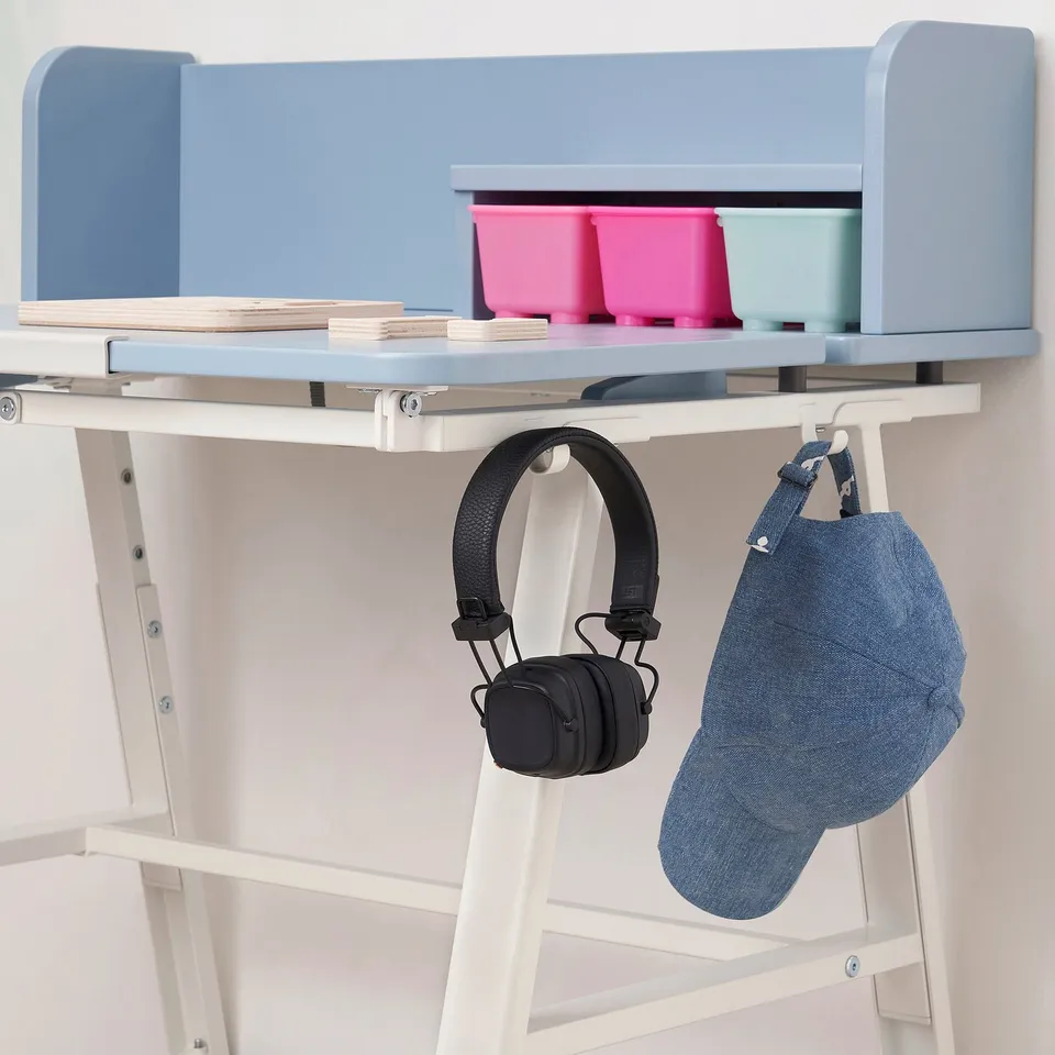 Desk with tilted tabletop, hooks for headphones and bag, storage bins.