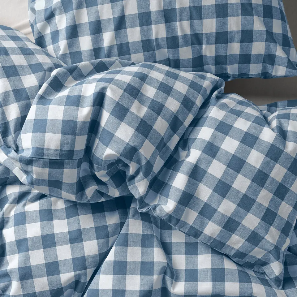 Blue & white gingham duvet set, neatly folded, showcasing soft, organic cotton texture.