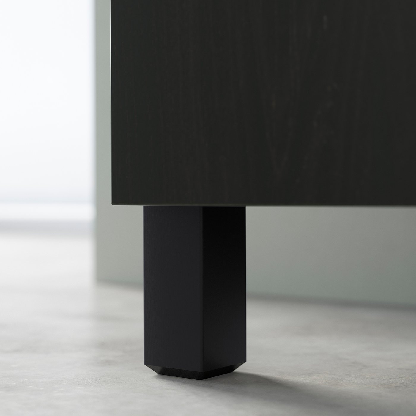 Black tv stand leg, modern design, part of BESTÅ collection, hexagonal shape, sturdy wood construction.