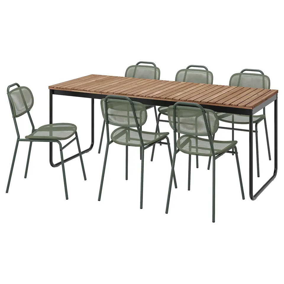 Six green metal chairs around rectangular acacia wood table.