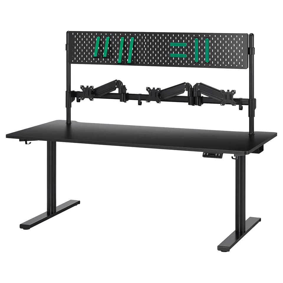 Black MÅLOMRÅDE gaming desk with 3 monitor arms, pegboard, and stand-up feature.