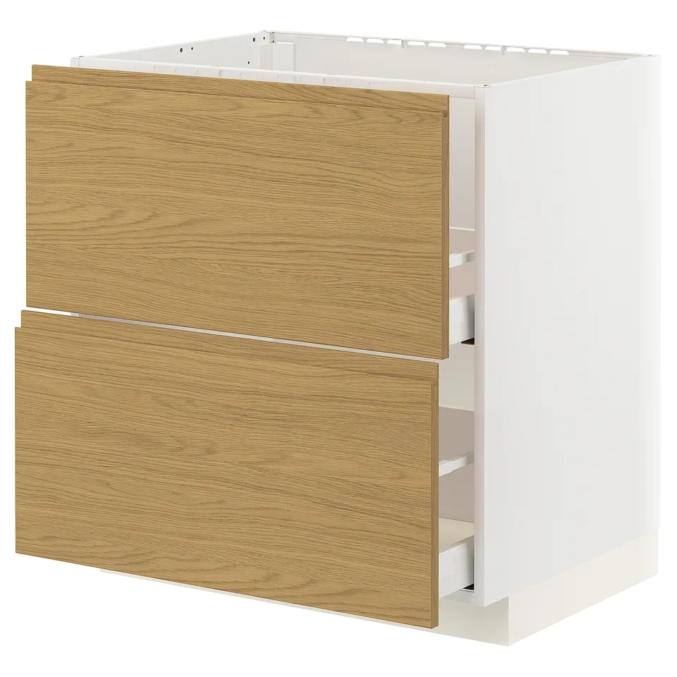 A white METOD kitchen cabinet with oak-colored drawers, simple design, and built-in handles.