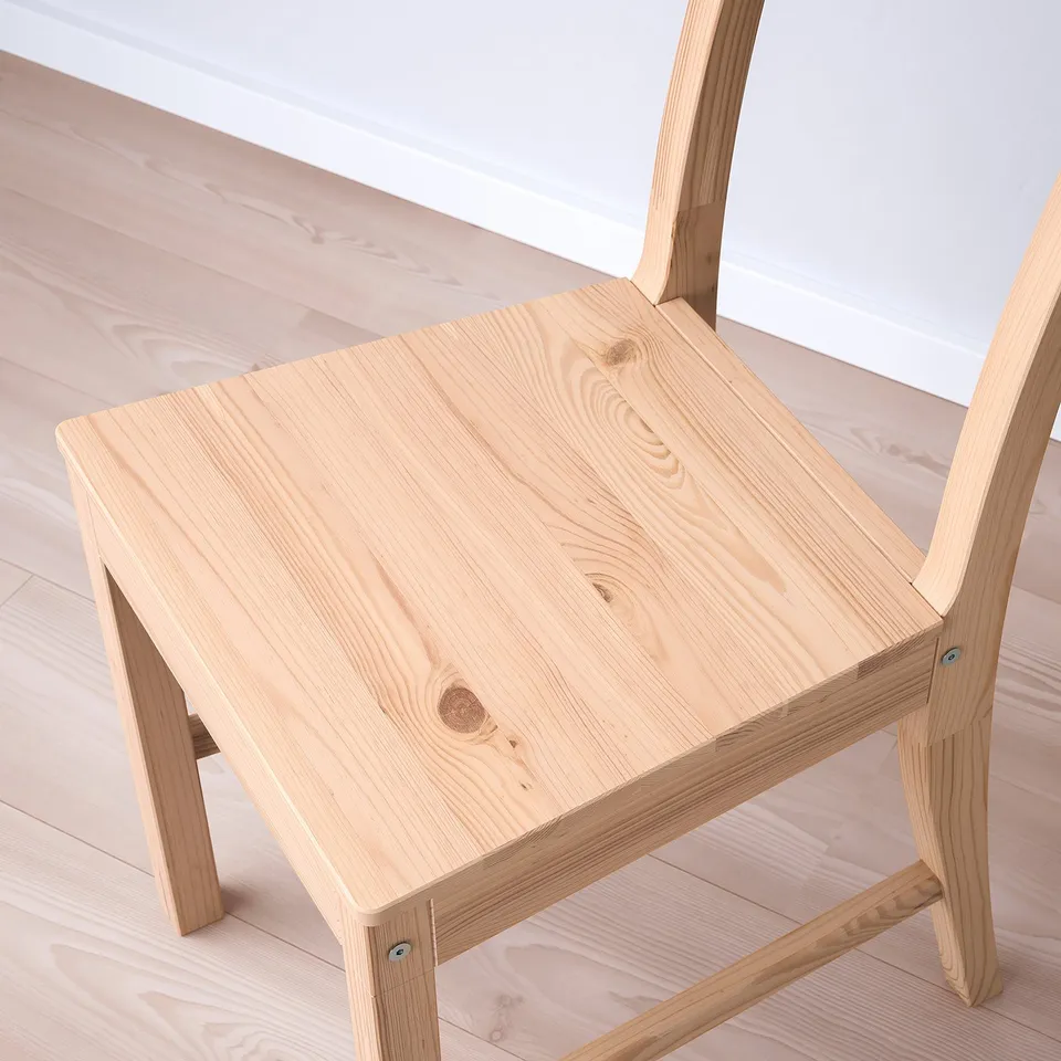 Small, sturdy wooden table and chair set. Light wood finish, visible grain texture. Excellent craftsmanship, solid construction.