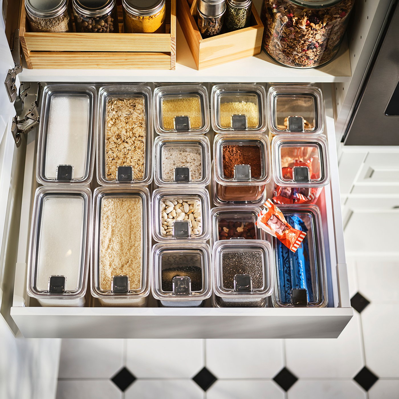 Kitchen drawer with jars of dry ingredients.