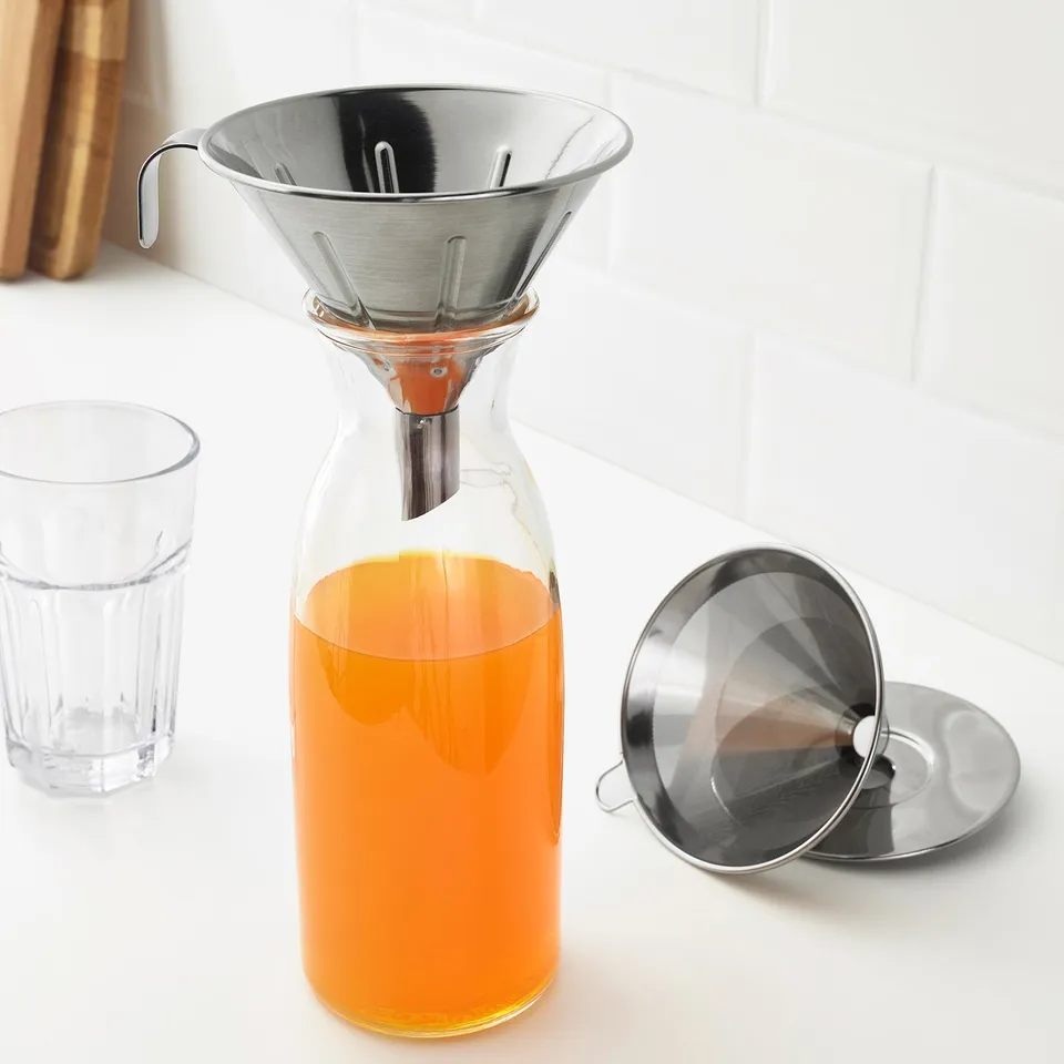 Stainless philtre on glass carafe with tea, eco-friendly reusable system.
