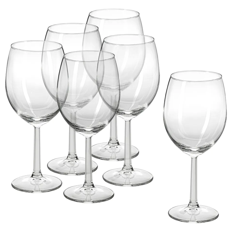 Six clear SVALKA wine glasses with long stems arranged in a triangular formation, perfect for elegant dining or entertaining.