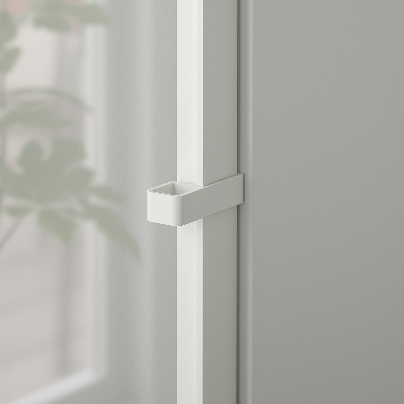 Close-up of a modern, sleek white door handle on a glass door, emphasising its clean design and high-quality metallic finish.