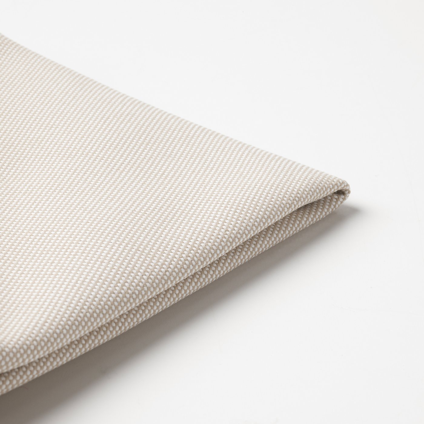 Light-colored, textured fabric close-up, showcasing fine weave and smooth texture.