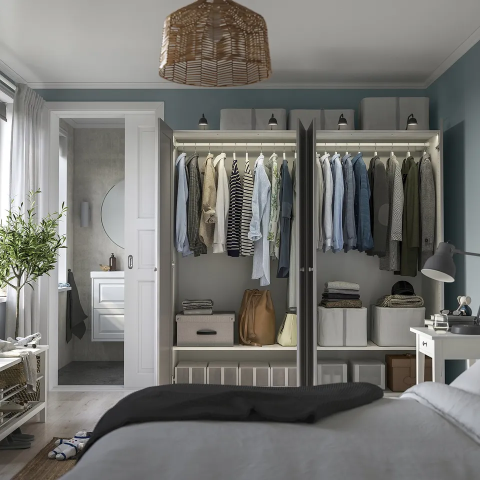 Modern bedroom with open wardrobe, neatly organised teal room.