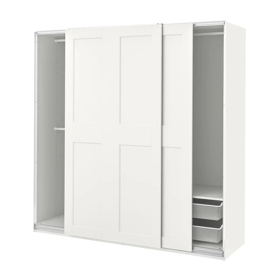 This image an all-white PAX wardrobe with sliding doors, mesh baskets, and adjustable interiors for versatile storage solutions.