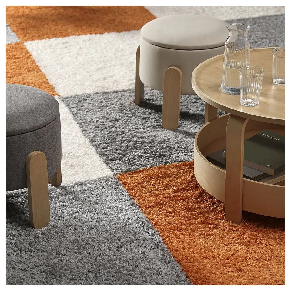ÄRENDE multicoloured rug with table and stools, clear vase, adds warmth
