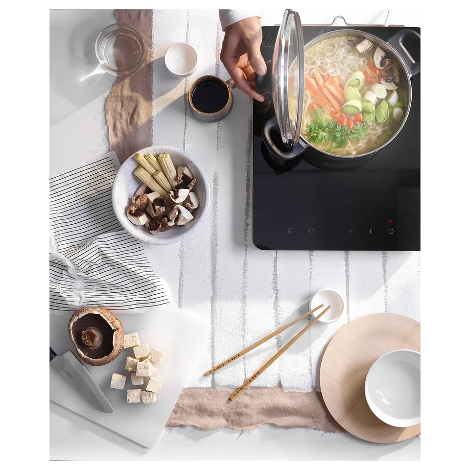 Induction cooking setup with ingredients.