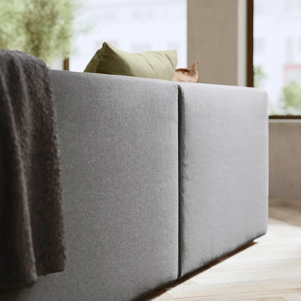 Modern grey JÄTTEBO sectional sofa, soft fabric, clean lines, with green pillow.