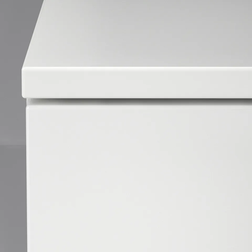 A close-up of a smooth, sleek white drawer front, showcasing its modern and clean design.