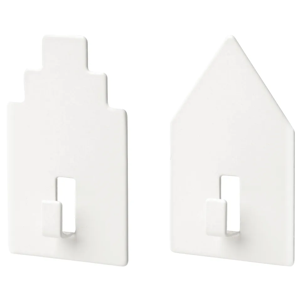 Two white self-adhesive wall hooks shaped like houses.