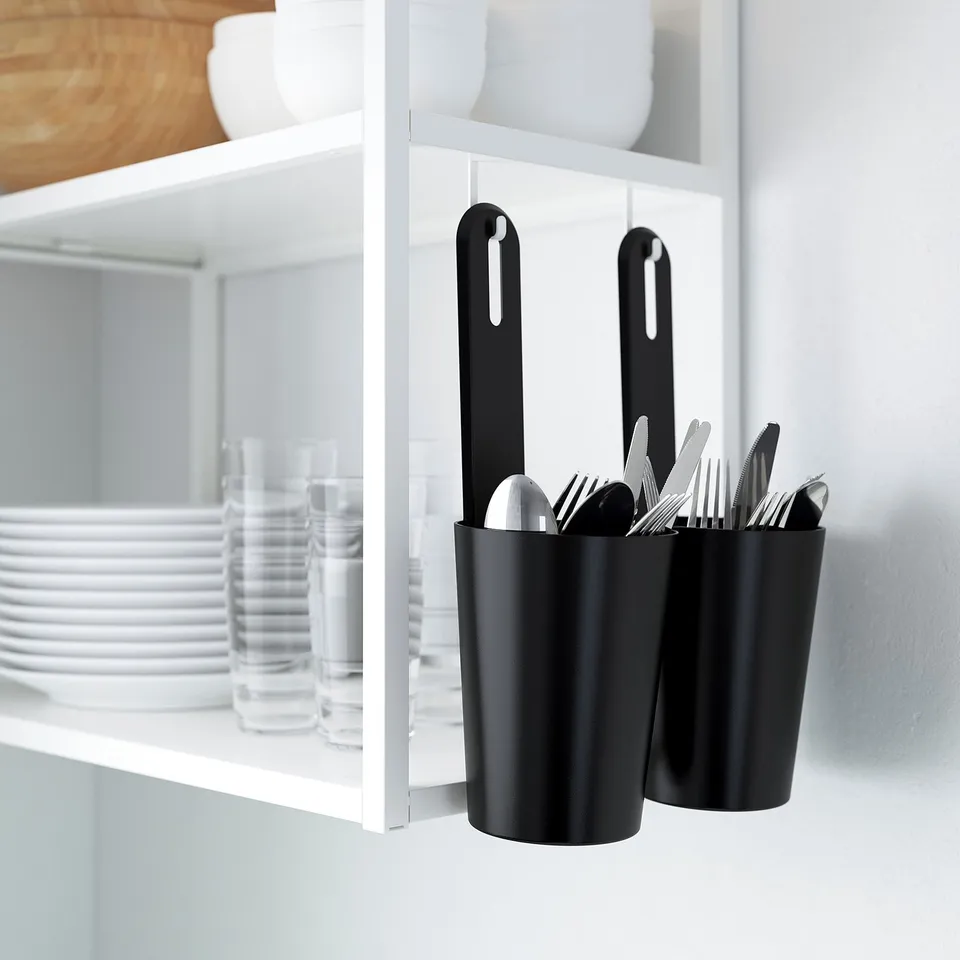 Black hanging storage rail with containers for kitchen utensils under ENHET shelf.