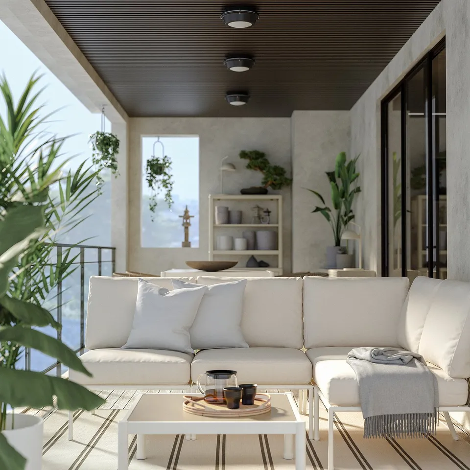 Modern outdoor patio with white SEGERÖN sofa, rug, coffee table, and potted plants.