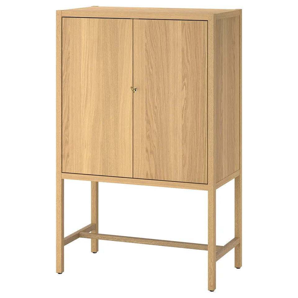 Modern wooden cabinet with light oak finish, two doors, adjustable shelves, and brass key lock.