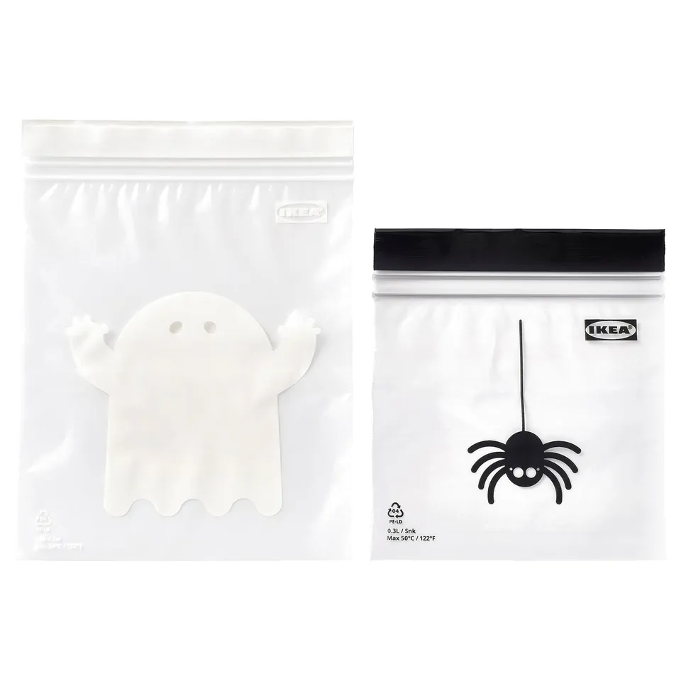 Two white IKEA zip bags: one with a ghost design, the other with a spider design.