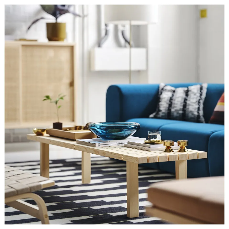 Modern scandinavian coffee table, STOCKHOLM 2025, in acrylic and pine. Fits near blue sofa with decor.