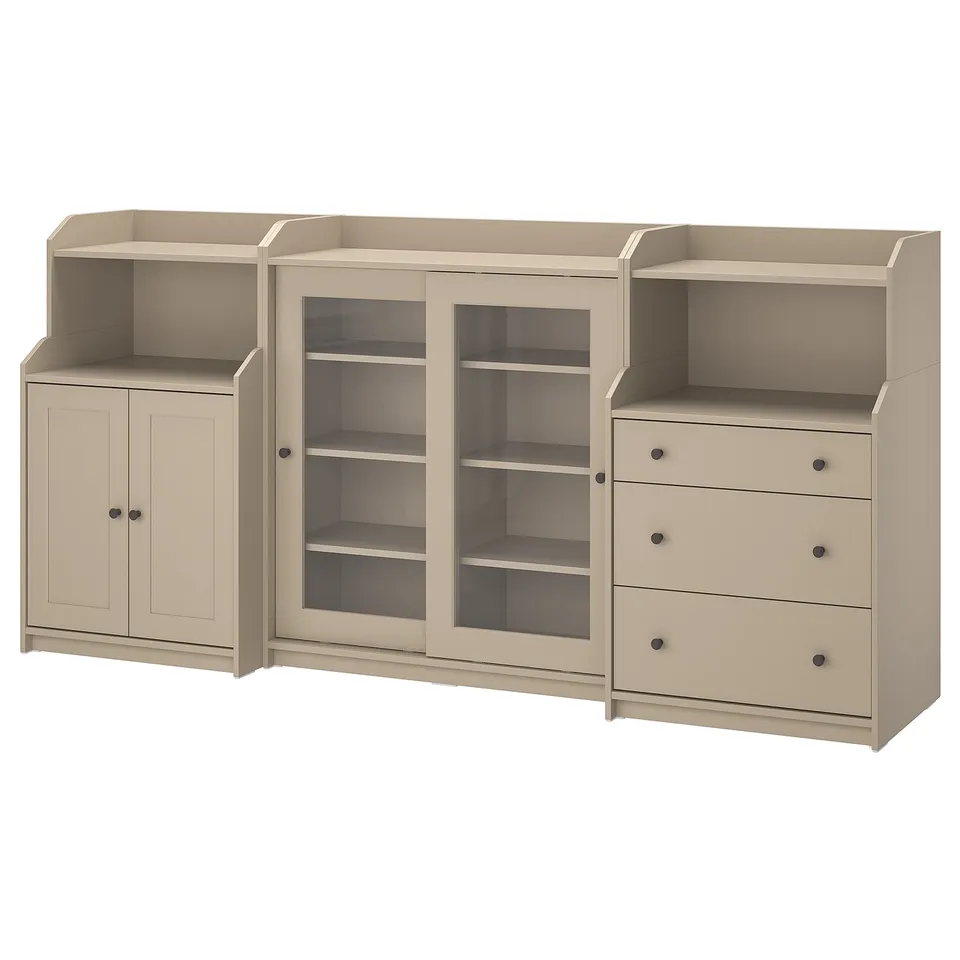 A beige HAUGA storage unit with a mix of open and closed shelves, glass doors, and three drawers.