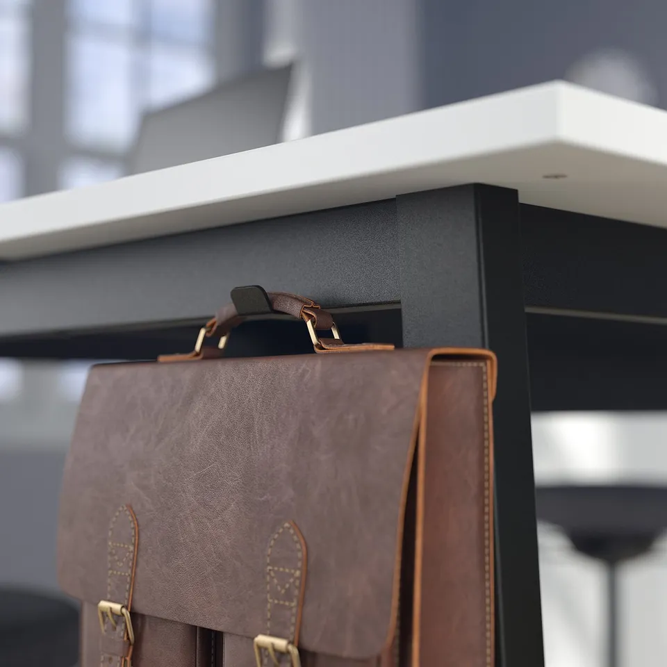 Brown leather bag hangs on black office shelf with hooks.