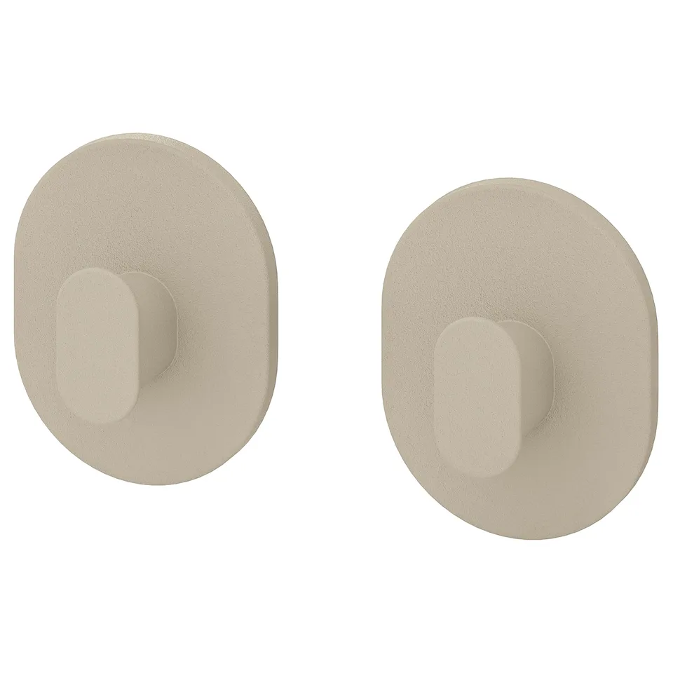 Pair of beige FLORSJÖN wall hooks, oval shape.