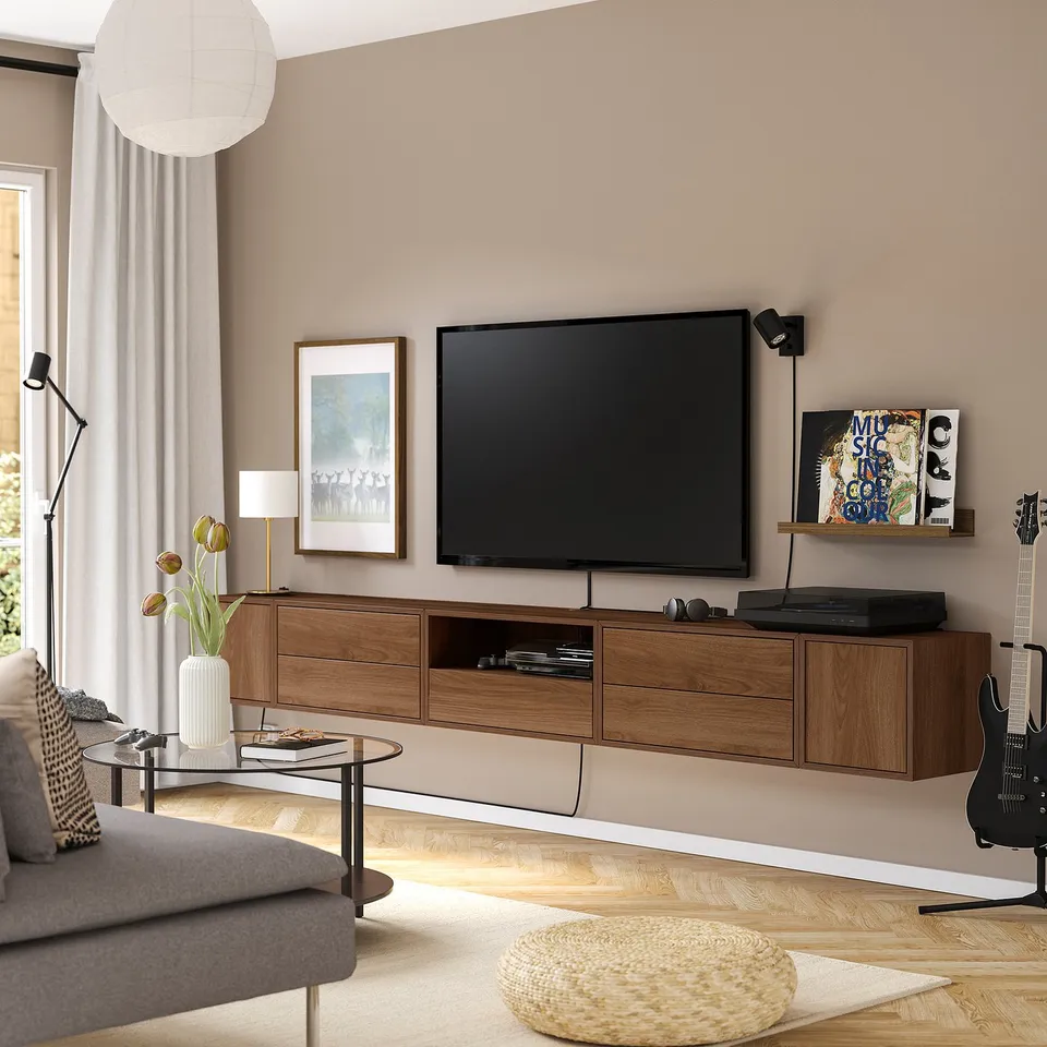 Modern living room with tv, sofa, record player, guitar & large window.