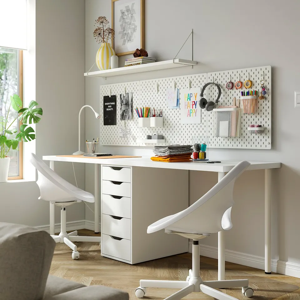 Bright home office with LAGKAPTEN white desk, organised pegboard, chair, and office supplies.