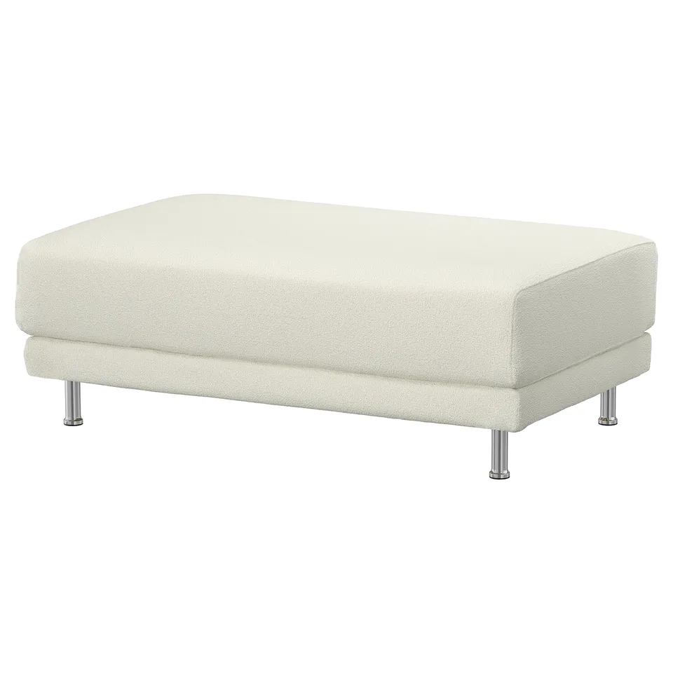 A cream-colored UPPÅKRA footstool with chrome legs. It is rectangular and upholstered in soft bouclé fabric.