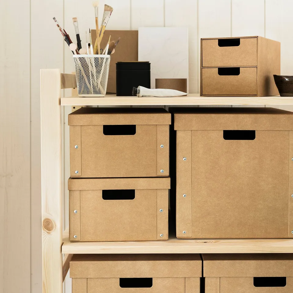 Brown gård storage boxes with handles, stacked on shelves.