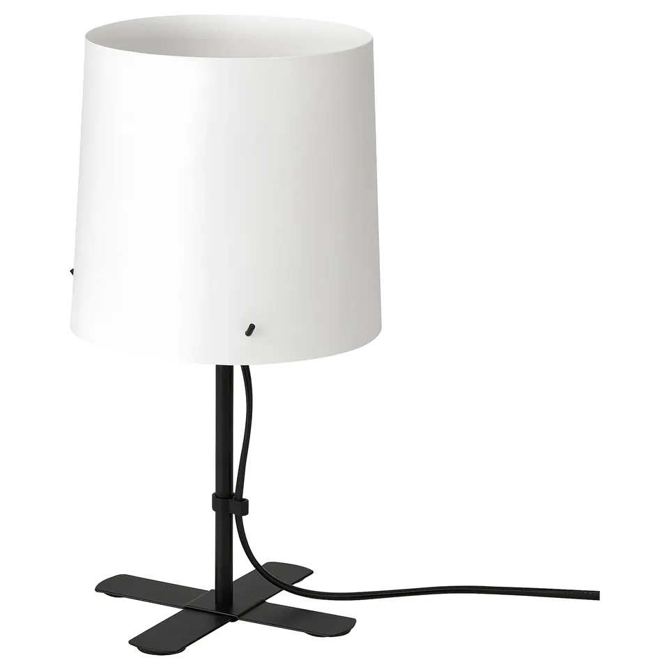 Black table lamp with white shade, modern design, stands on three arms, adjustable height.