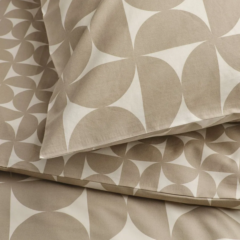 Patterned fabric close-up showcasing intricate, geometric shapes. Textured, crisp, and soft material in neutral tones.