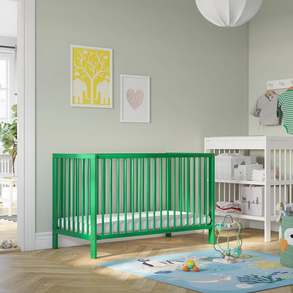 Bright green GULLIVER cot, modern nursery, soft toys, colourful rug.